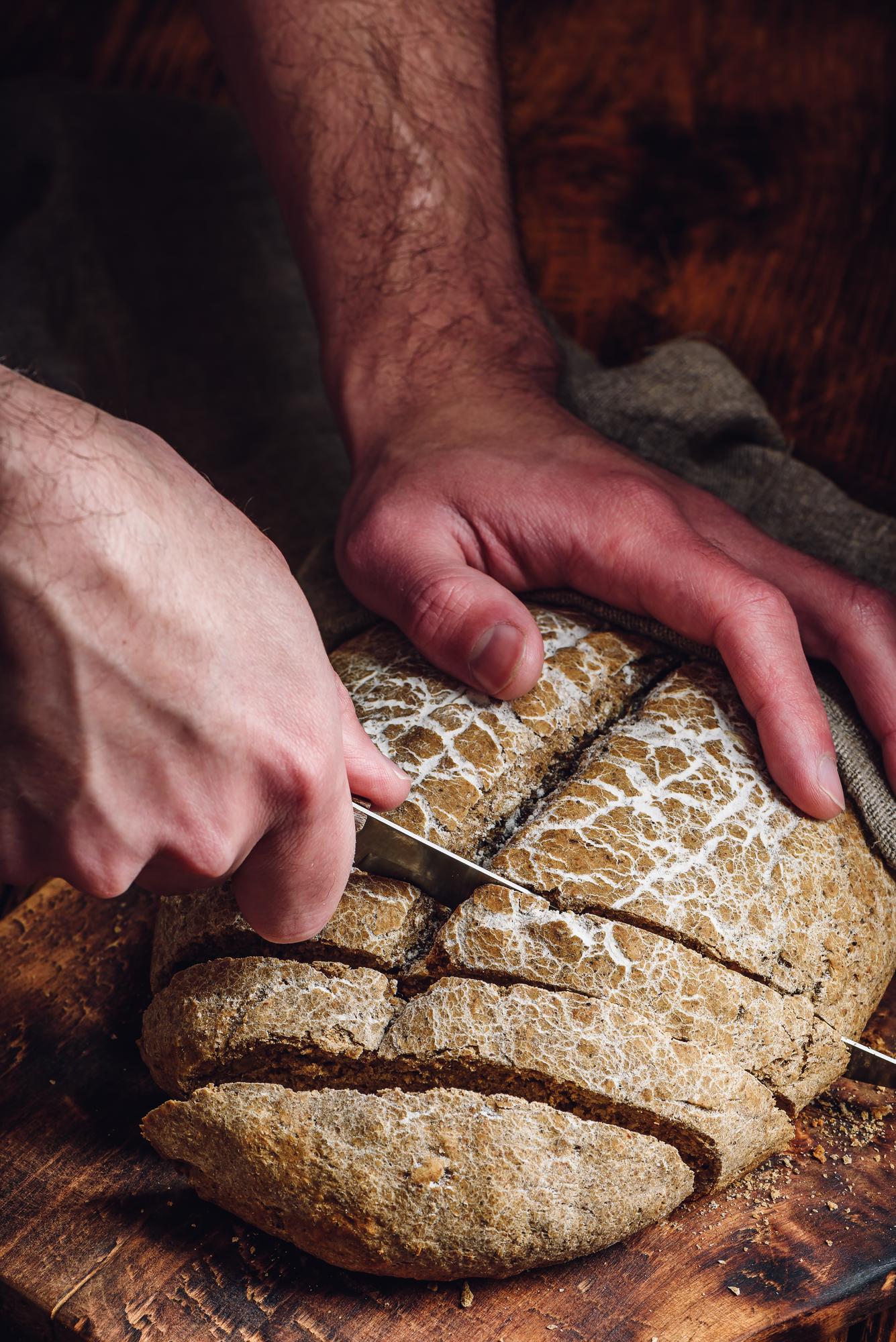 Baker shaping sourdough loaf